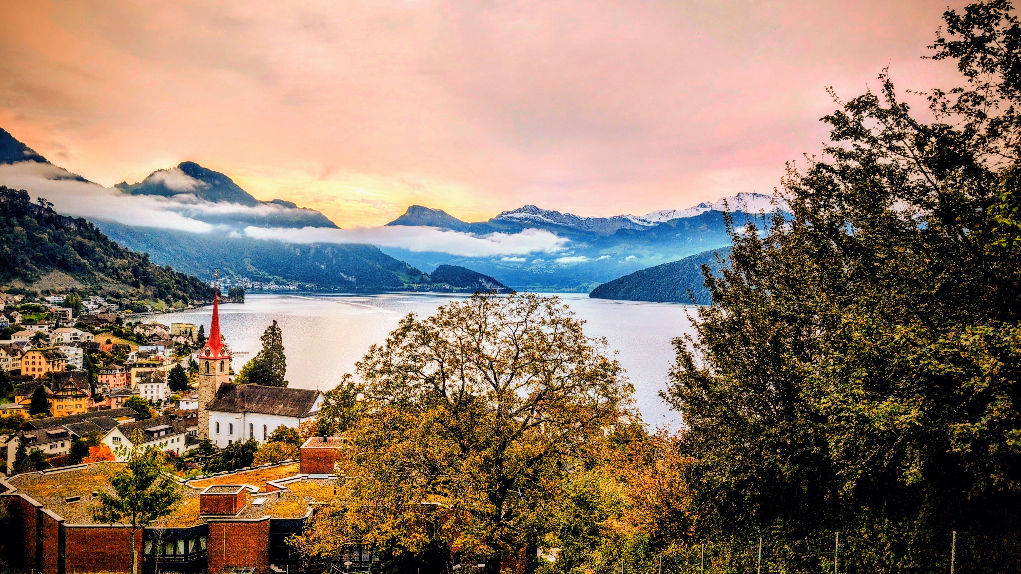 A panoramic view of Lake Lucerne with the Alps in the background before sunset