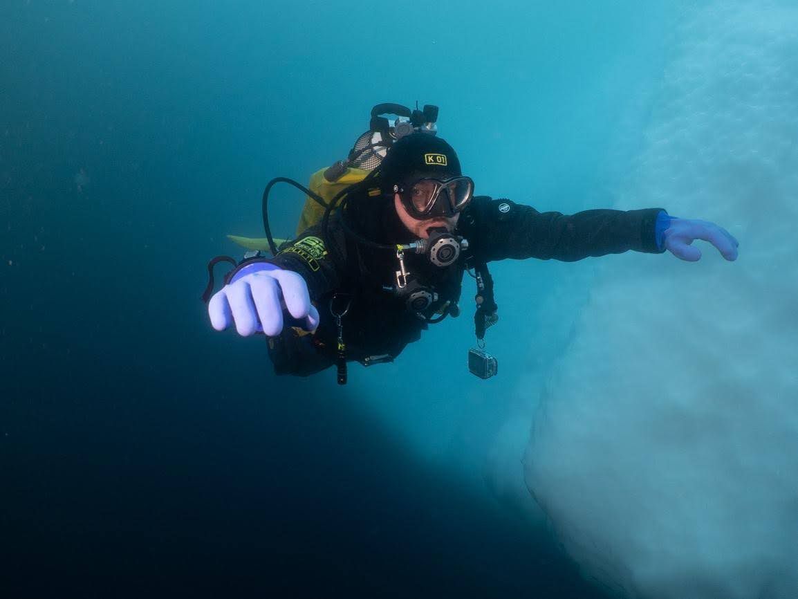 Martin diving next to an iceberg in Antarctica